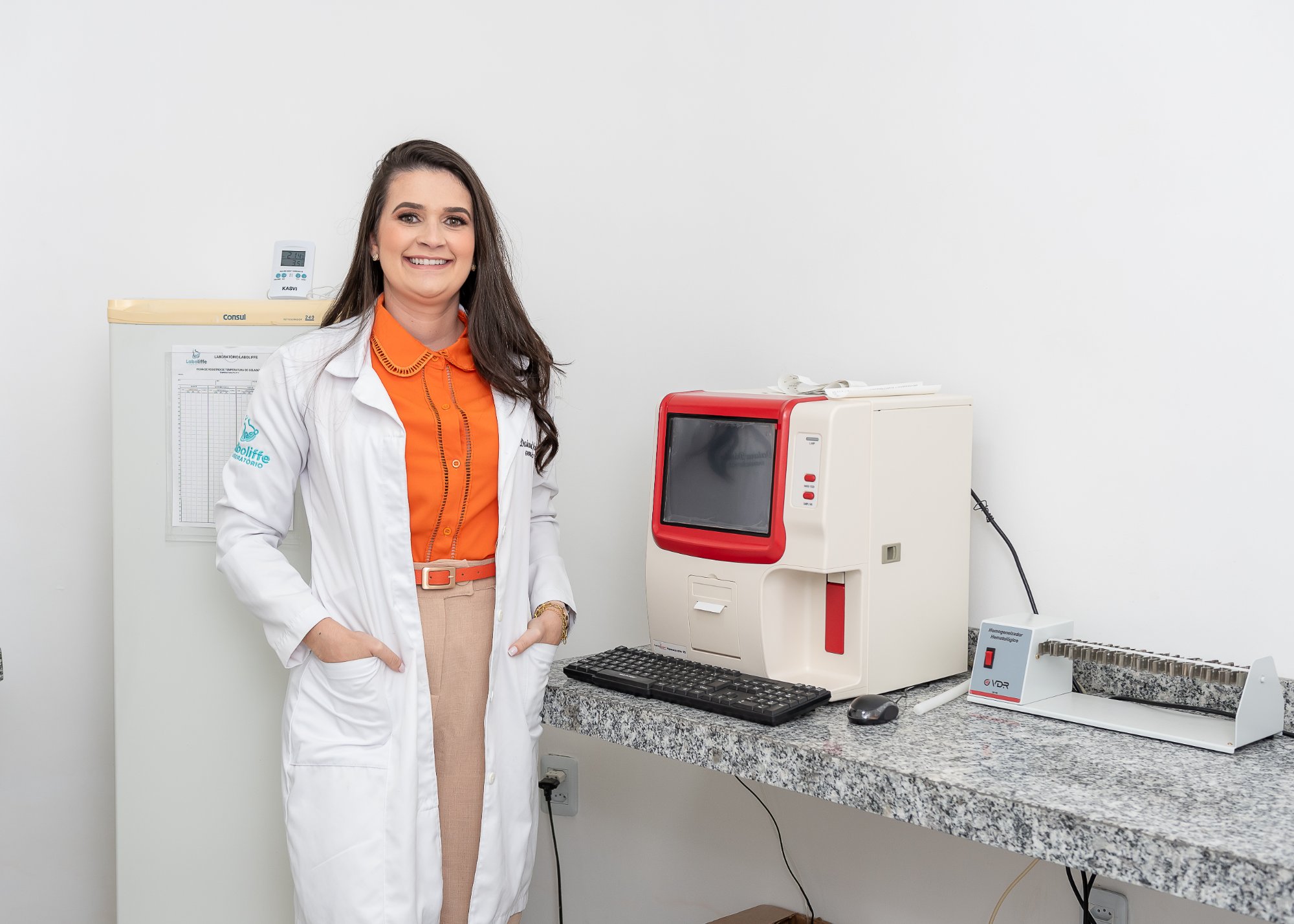 Profissional do Laboliffe ao lado de equipamento laboratorial de última geração